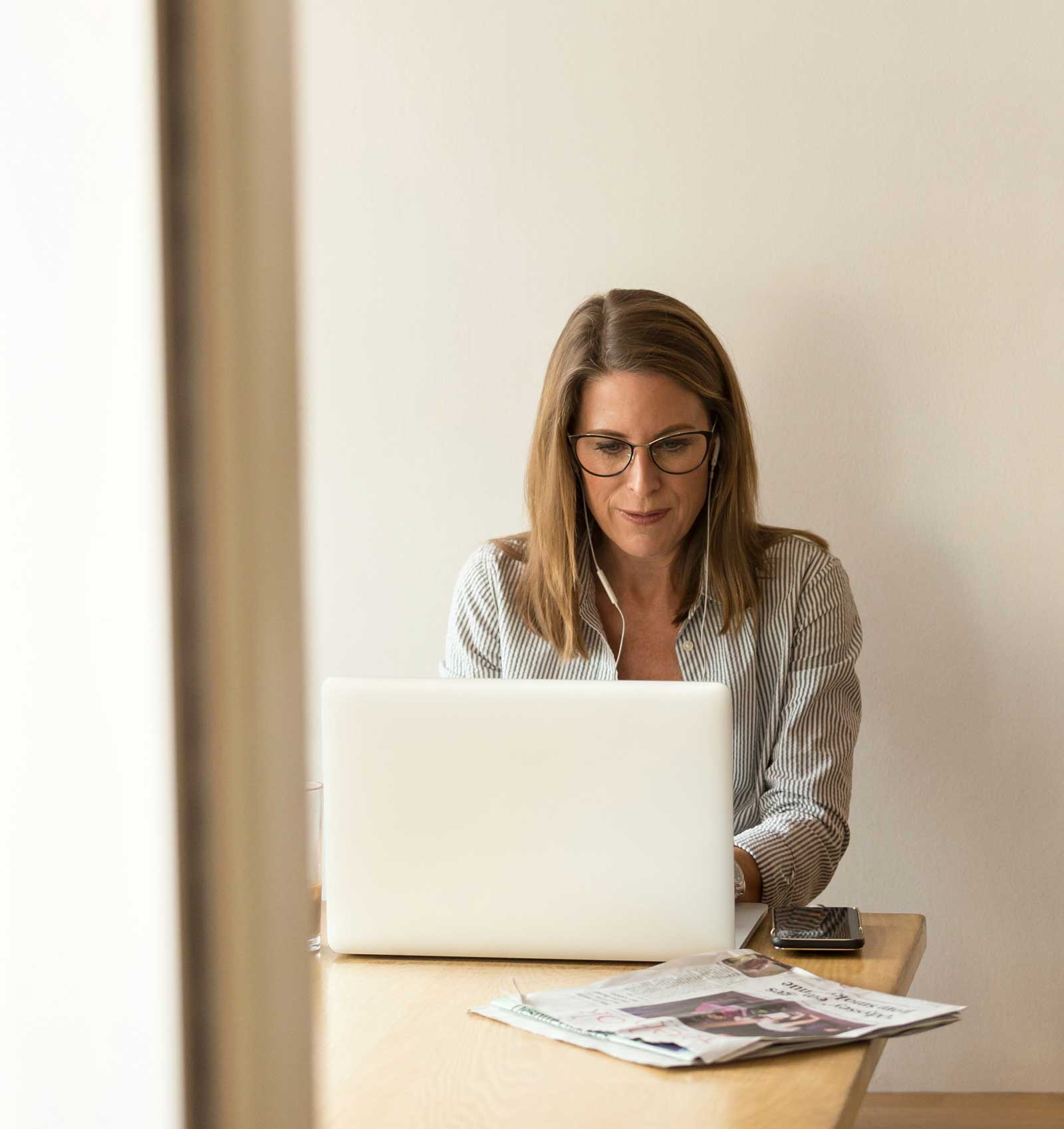 Woman working on laptop smiling